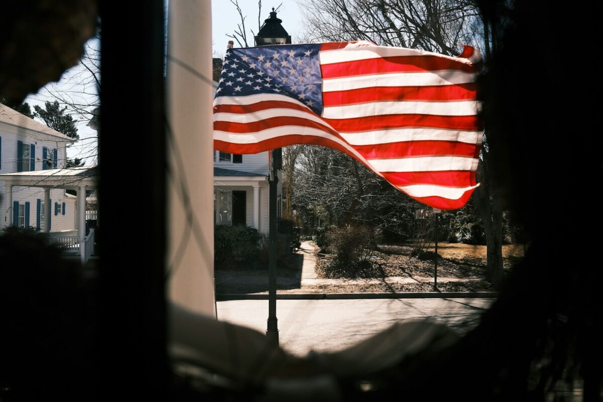 a large american flag flying in the wind